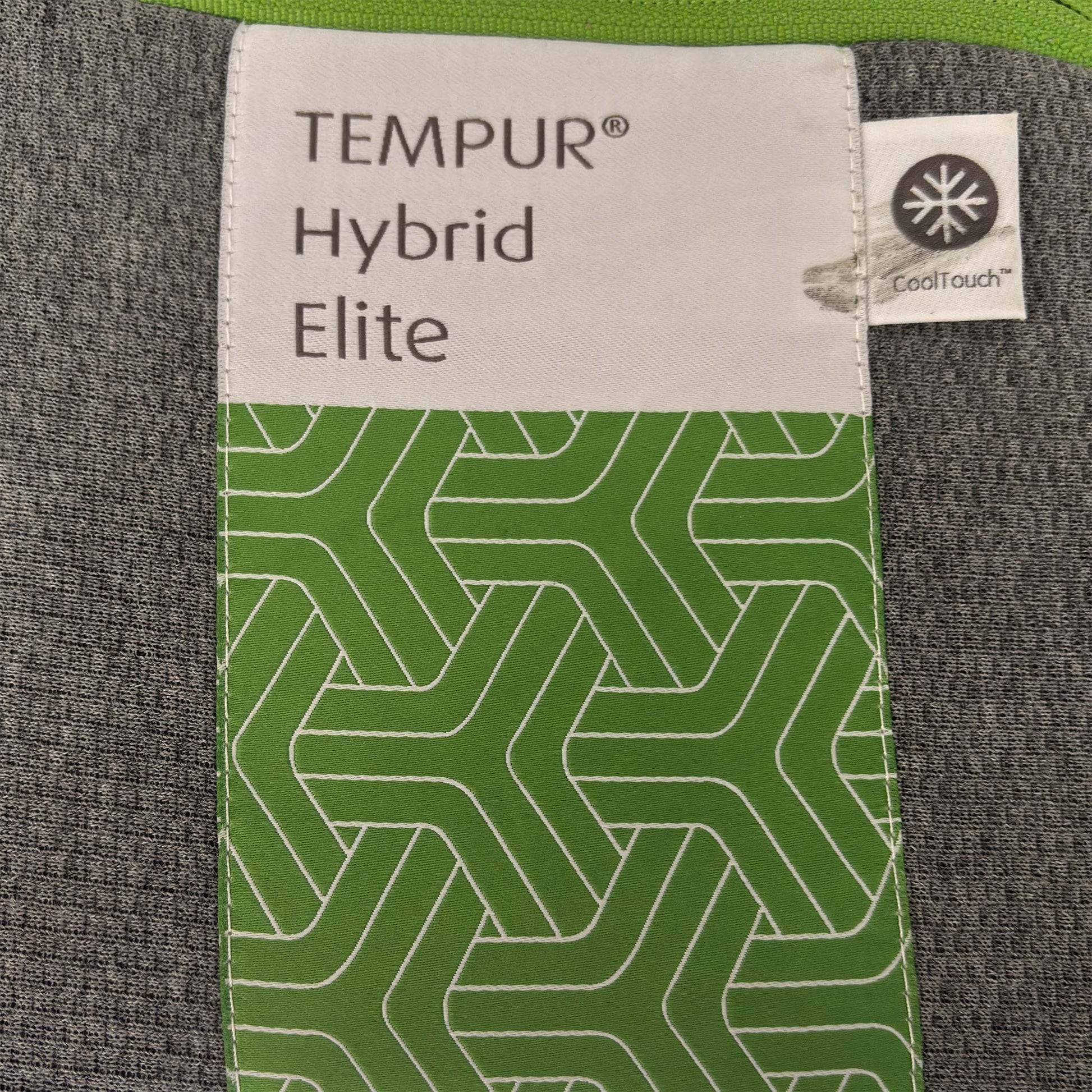 Close-up of the TEMPUR quilted mattress cover, highlighting the breathable fabric texture and the iconic TEMPUR branding on the mattress corner.