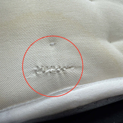 Close-up of a small area of damage on the mattress surface, as noted in the clearance product description.