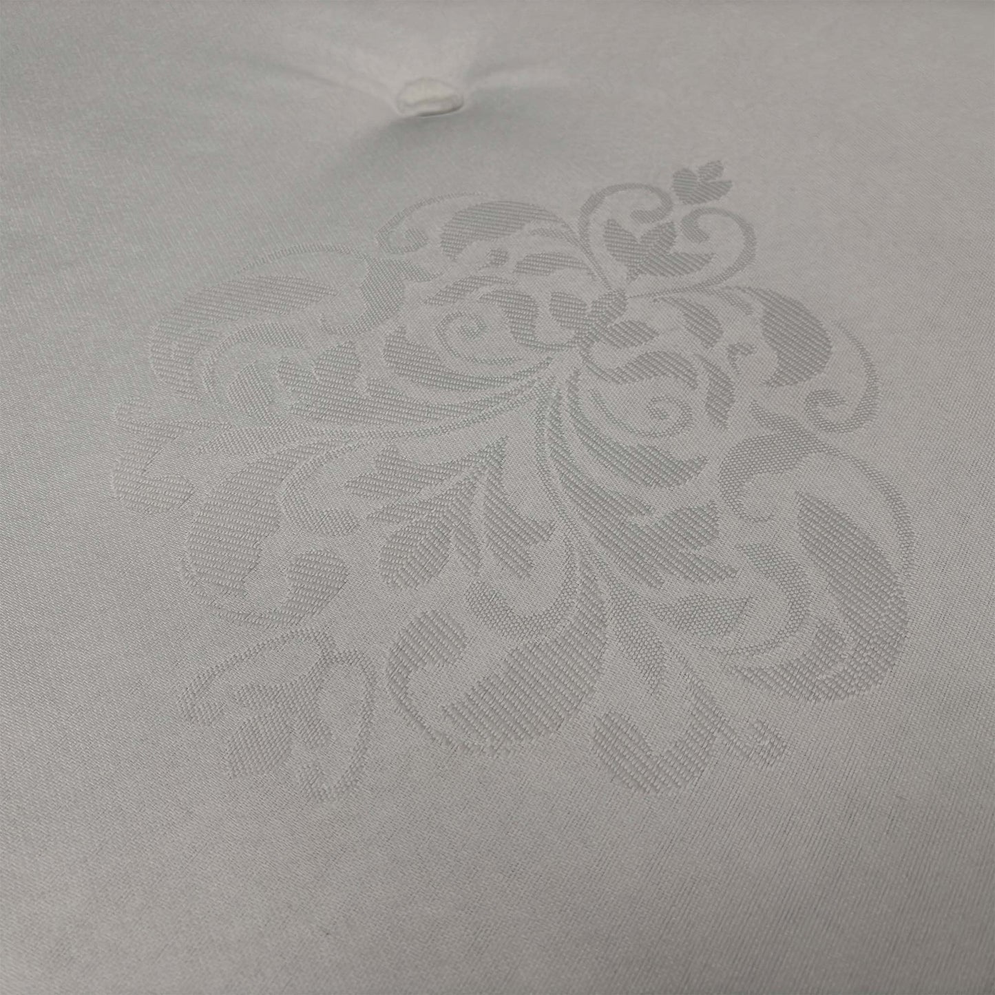 Close-up of the diamond-quilted damask cover, emphasizing the textured floral pattern and the breathable fabric designed to maintain a fresh sleeping environment.