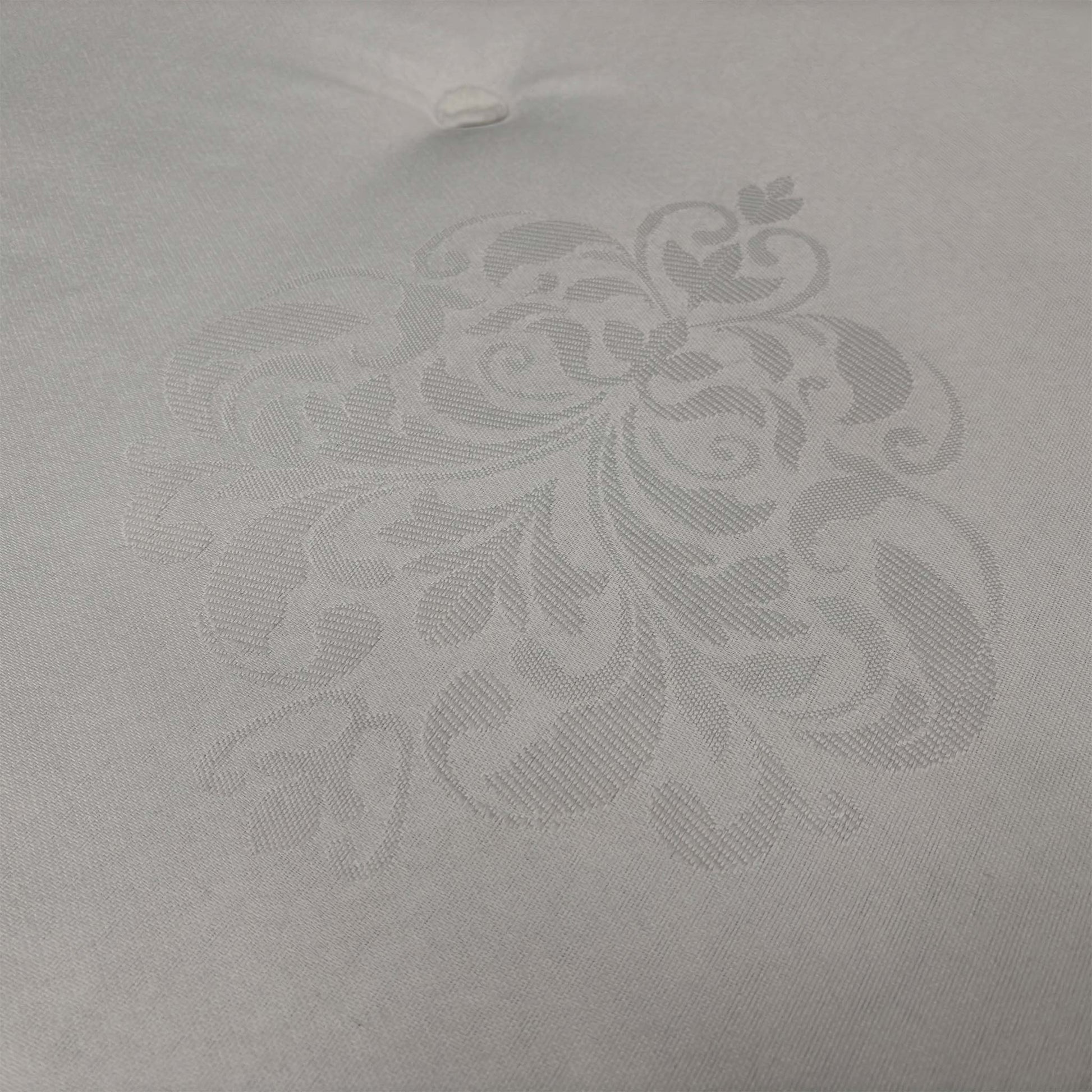 Close-up of the diamond-quilted damask cover, emphasizing the textured floral pattern and the breathable fabric designed to maintain a fresh sleeping environment.