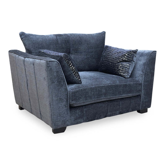 Full view of the ‘Allure’ snuggler chair in Coco Indigo woven fabric, featuring a classic back design, deep cushioned seating, and elegant tapered wooden legs.