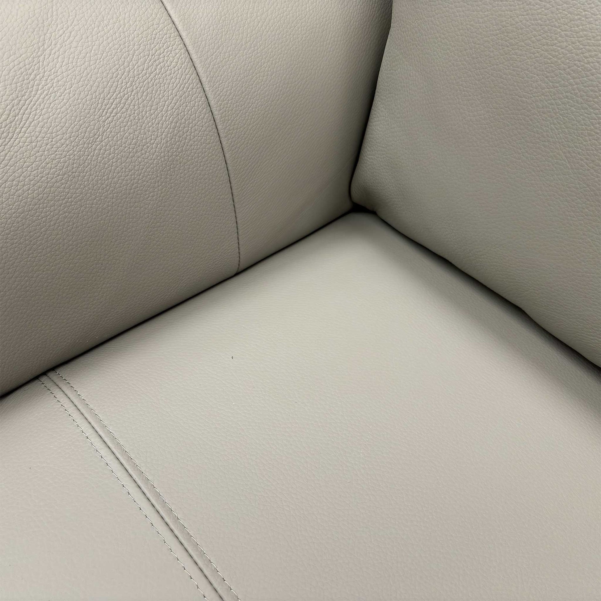 High-angle view of the seat cushions and headrests, highlighting the ergonomic stitching and plush padding.