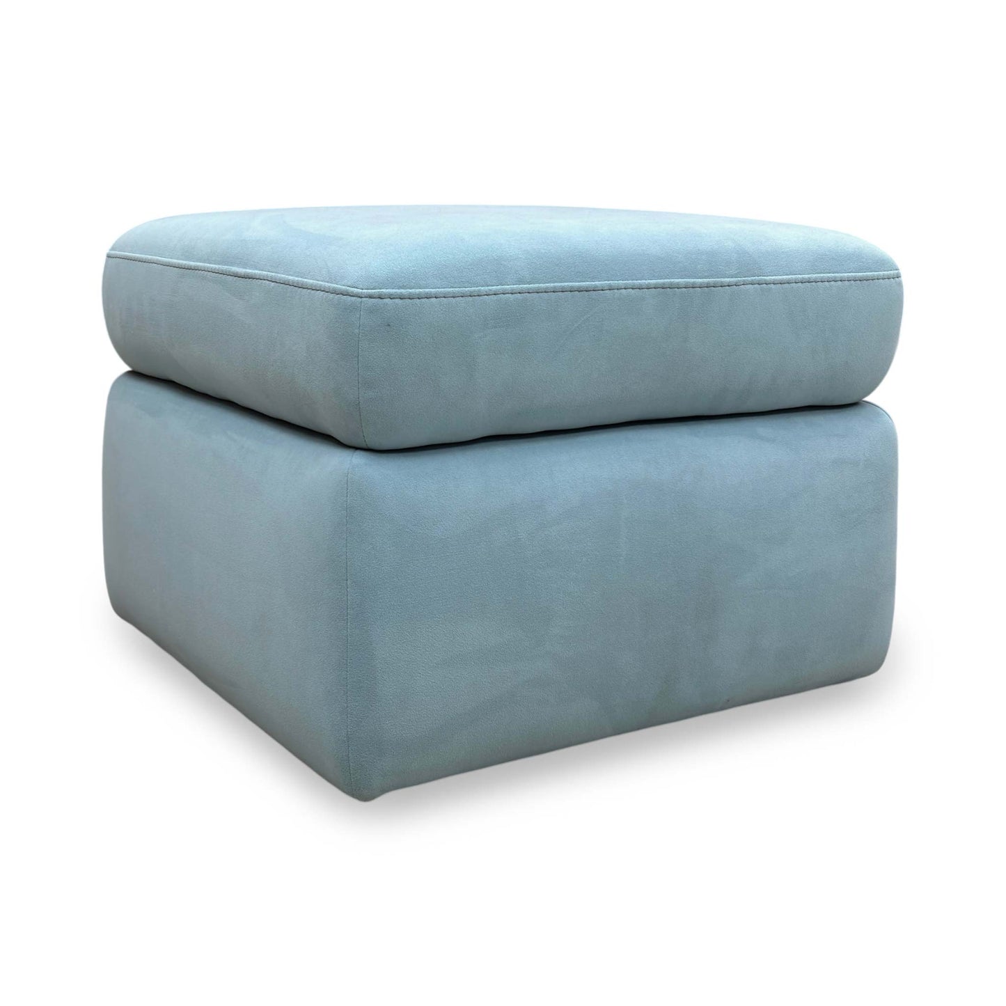 Side profile of the footstool, highlighting the thick padded top and the consistent velvet upholstery across all panels.