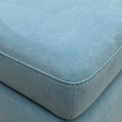 Close-up of the baby blue velvet upholstery, emphasizing the plush texture and the light, vibrant color tone.