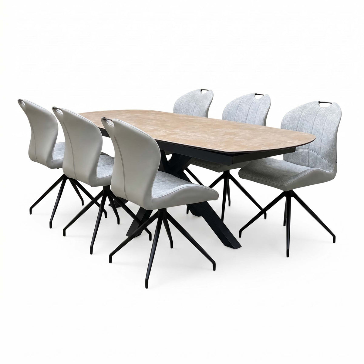 Raul extending dining table at full length with six stone grey swivel chairs, angled from the right
