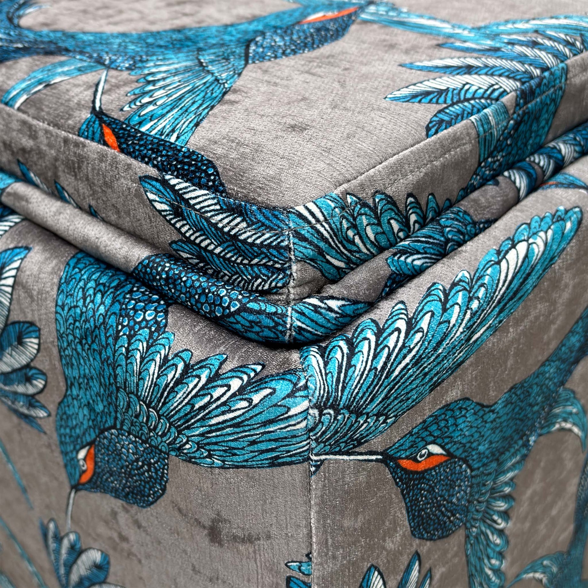 Close-up of the "Paradise Bird Grey" fabric, highlighting the intricate bird and floral pattern and the high-quality weave.