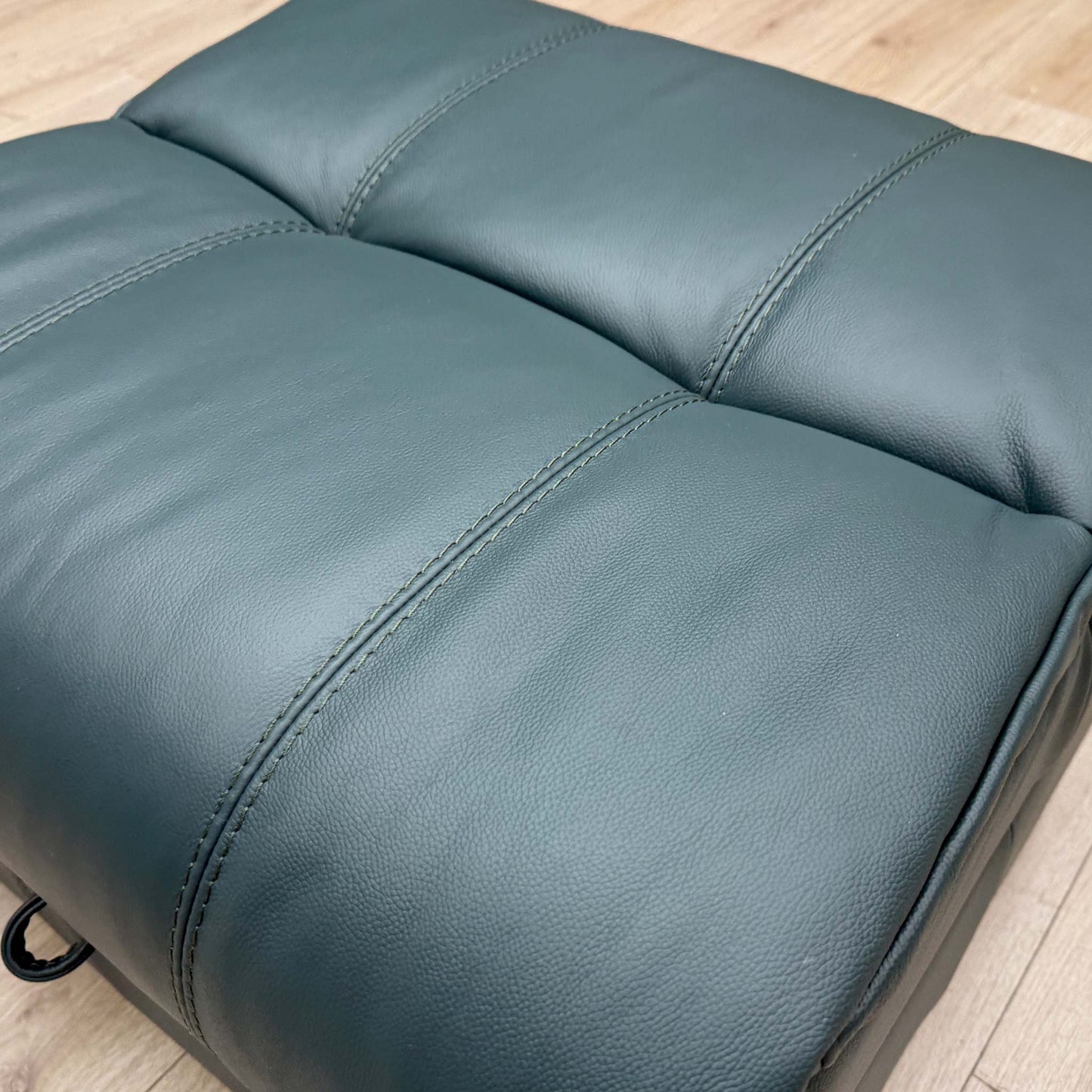 Close-up of the Lake Green leather, highlighting the premium grain texture and unique deep teal-green color tone.