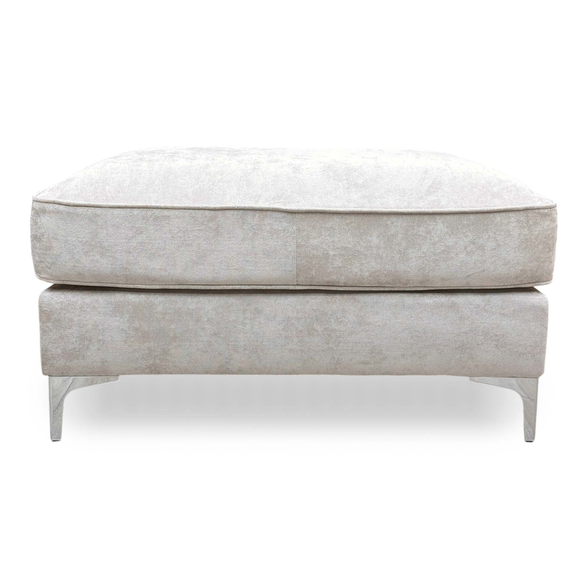 Front view of the silver fabric footstool, showcasing the classic Chesterfield-style tufting and structured rectangular shape.