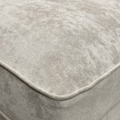 Close-up of the silver fabric, emphasizing the soft texture, subtle sheen, and the precise button-tufting detail.