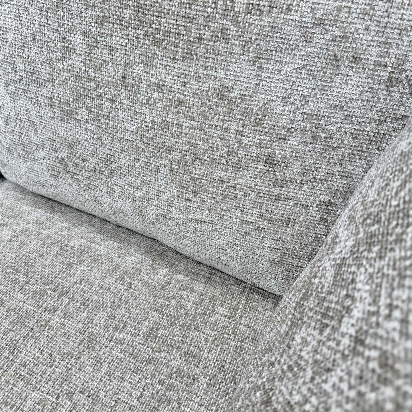 Close-up of the Stone woven fabric, emphasizing the durable multi-tonal weave and the soft, tactile quality of the material.
