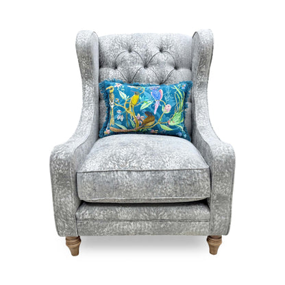 Front view of the Blenheim Winged Accent Chair upholstered in Savoy silver fabric, featuring a classic winged high back and dark wood legs.