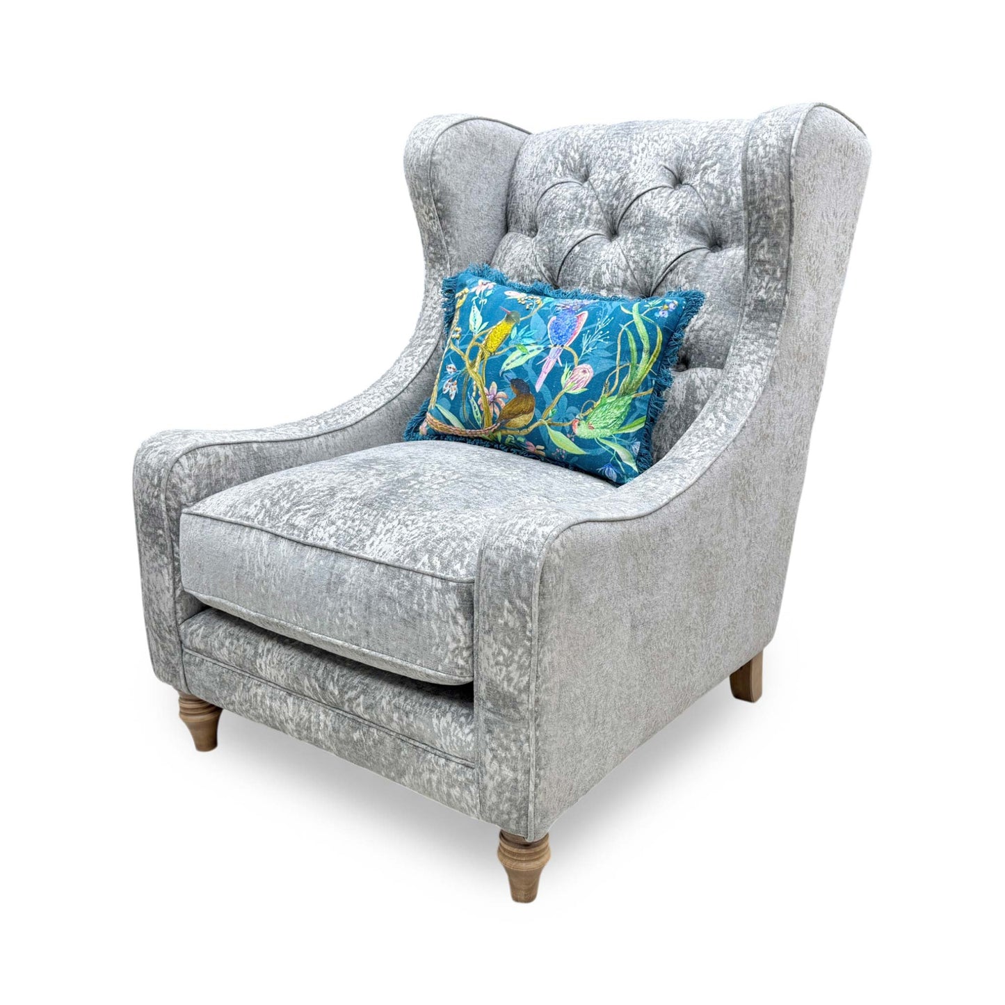 Angled view of the chair from behind, showing the clean tailoring and the sophisticated curve of the winged design.