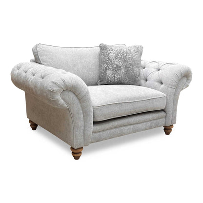 Full view of the silver fabric snuggler chair, showcasing the wide seat area and plush, supportive cushions.