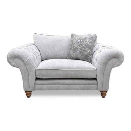 Front view of the silver fabric snuggler chair, showcasing the wide seat area and plush, supportive cushions.