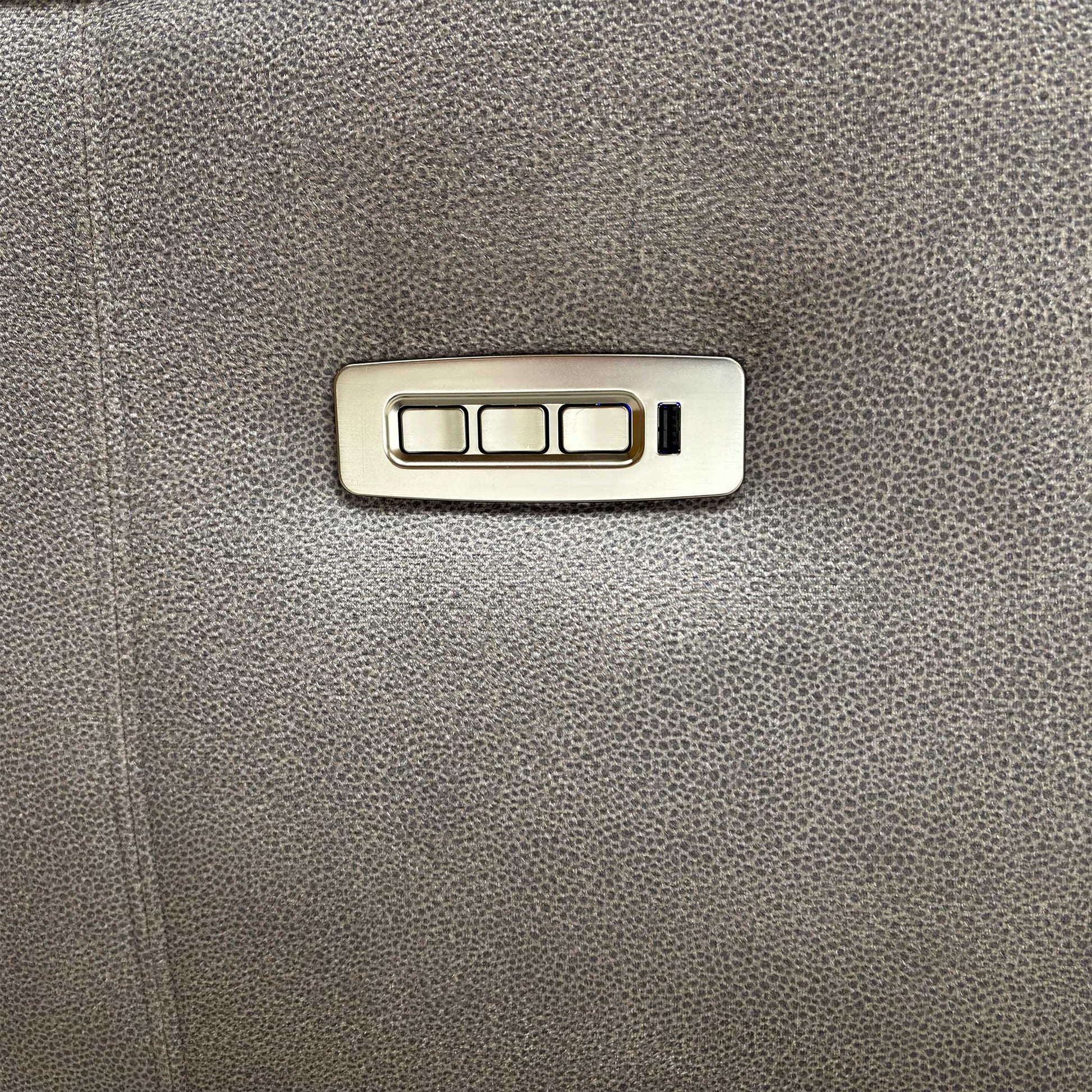 Close-up of the integrated USB charging port and power control buttons located on the side for convenient adjustment and device charging.