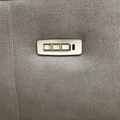 Close-up of the integrated USB charging port and power control buttons located on the side for convenient adjustment and device charging.