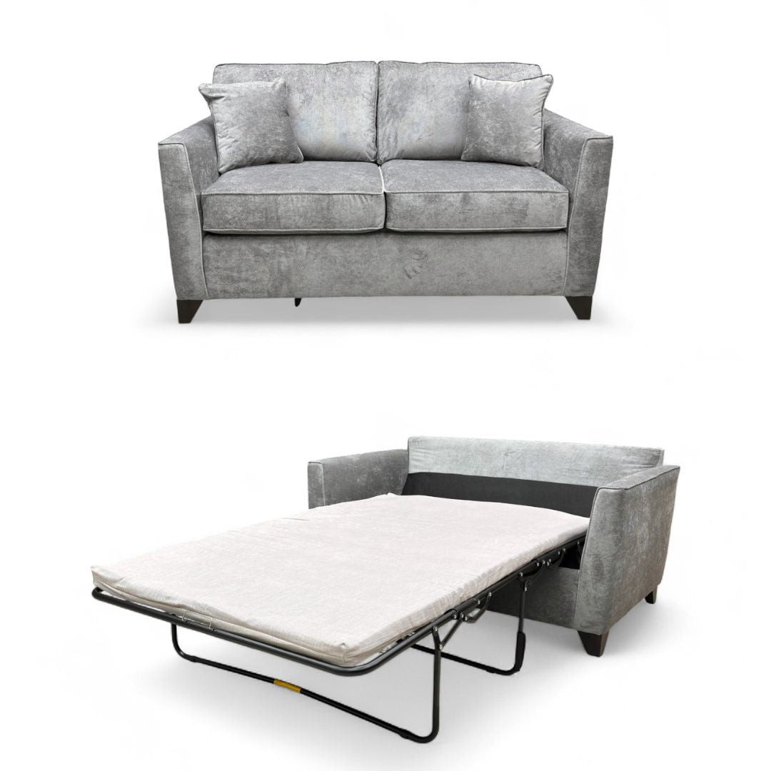 Angled view of the ‘Smith’ 2 Seater Sofa Bed in the sofa position, showing the full grey Kingston fabric upholstery and plump cushions.