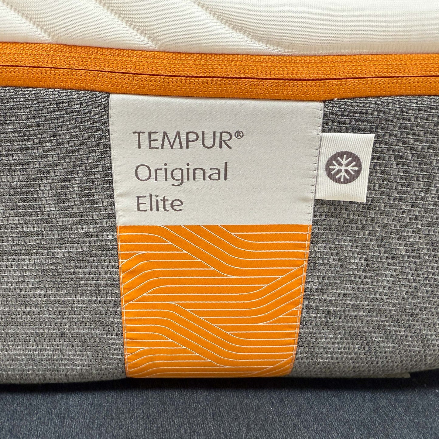 High-definition close-up macro view of the specialized QuickRefresh cover fabric, detailing the advanced knitted textile patterns, breathable weave, and zipper line.