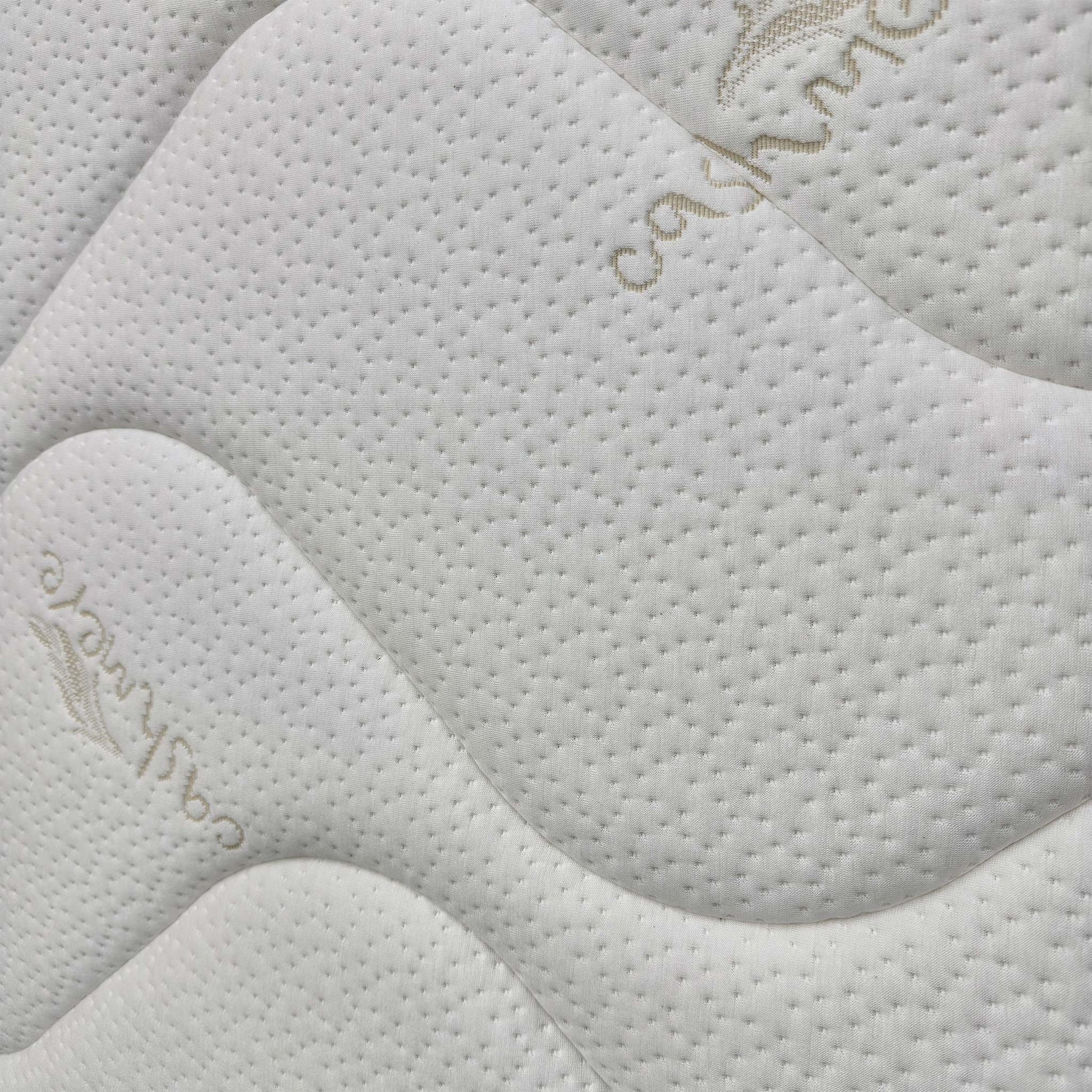 Close-up of the premium damask fabric, highlighting the traditional tufted finish that keeps the internal fillings secure and provides a firmer feel.