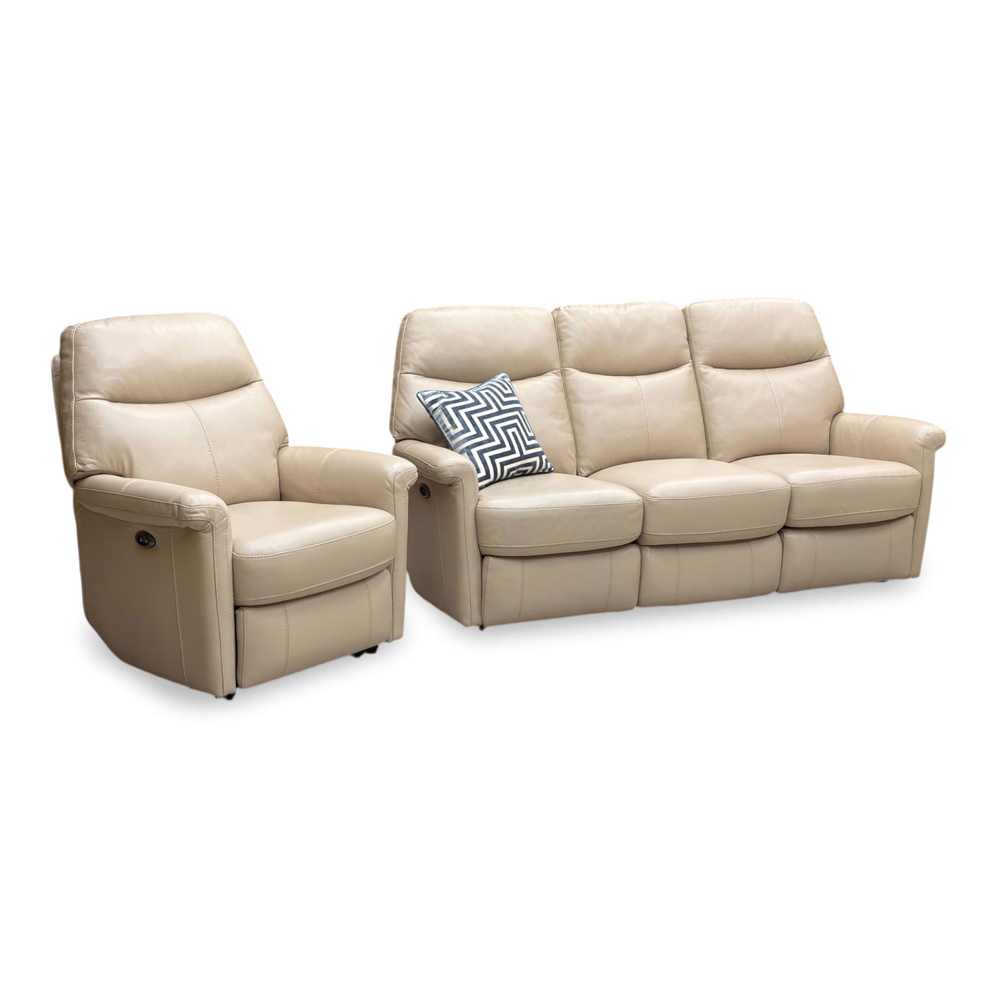 View of the power recliner footrest fully extended, noting a minor crease or surface wear on the leather fold.