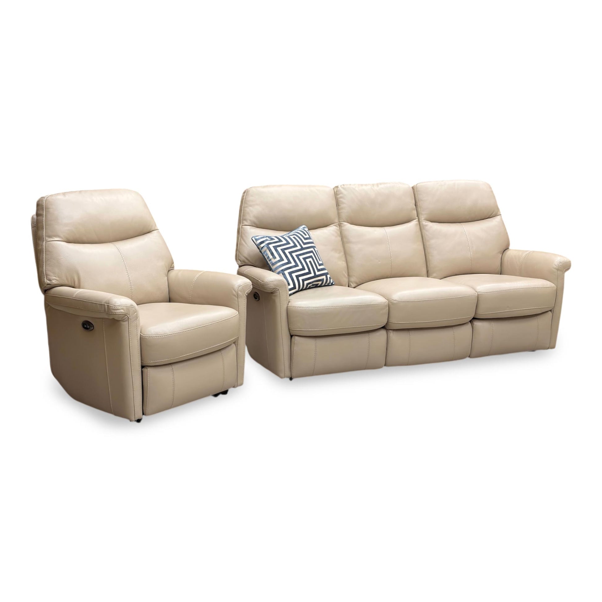 View of the power recliner footrest fully extended, noting a minor crease or surface wear on the leather fold.