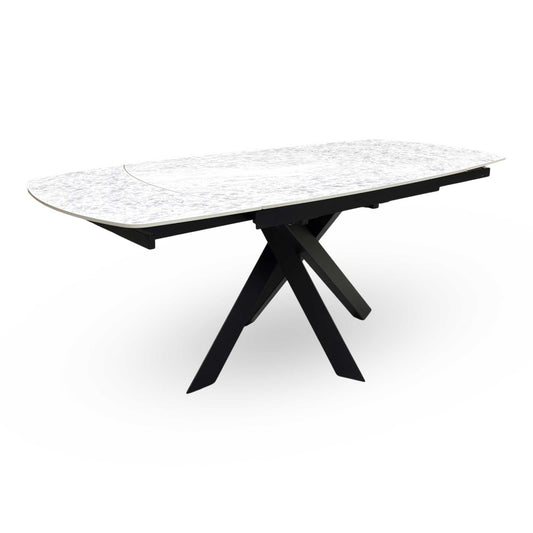 Full view of the ‘Warrior’ 120cm swivel extending dining table featuring a premium crystal white marble-effect ceramic top and a bold black powder-coated asymmetric metal base.