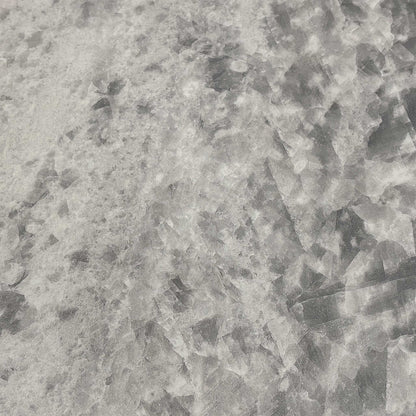 Close-up of the crystal white ceramic tabletop, emphasizing the realistic marble veining and the heat, scratch, and stain-resistant properties of the sintered stone.
