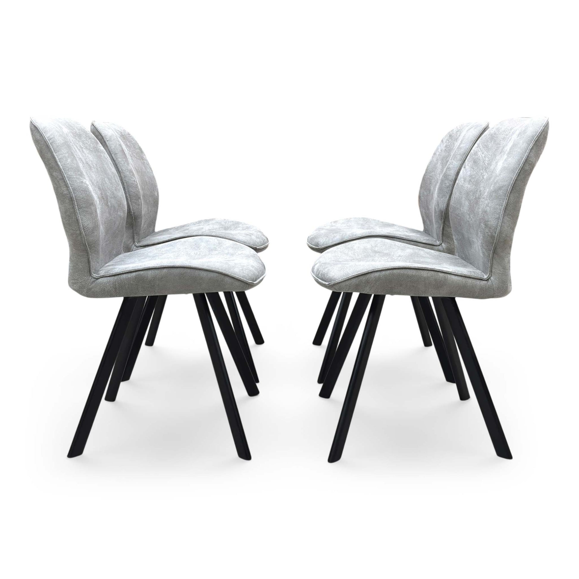 Front-facing view of a Montreal grey velvet dining chair, highlighting the plush padded seating surface and elegant transitional backrest design.
