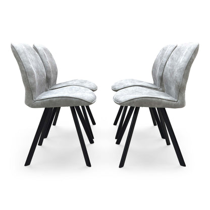 Front-facing view of a Montreal grey velvet dining chair, highlighting the plush padded seating surface and elegant transitional backrest design.