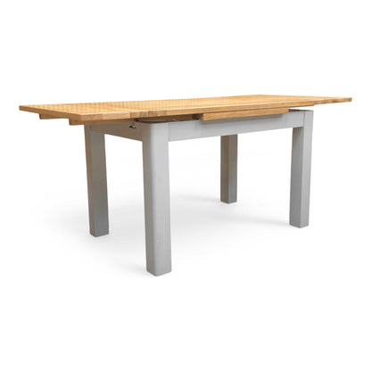 Full view of the 'Lewis' 120cm large draw-leaf extending dining table in solid oak, featuring a classic natural wood finish and sturdy square legs.