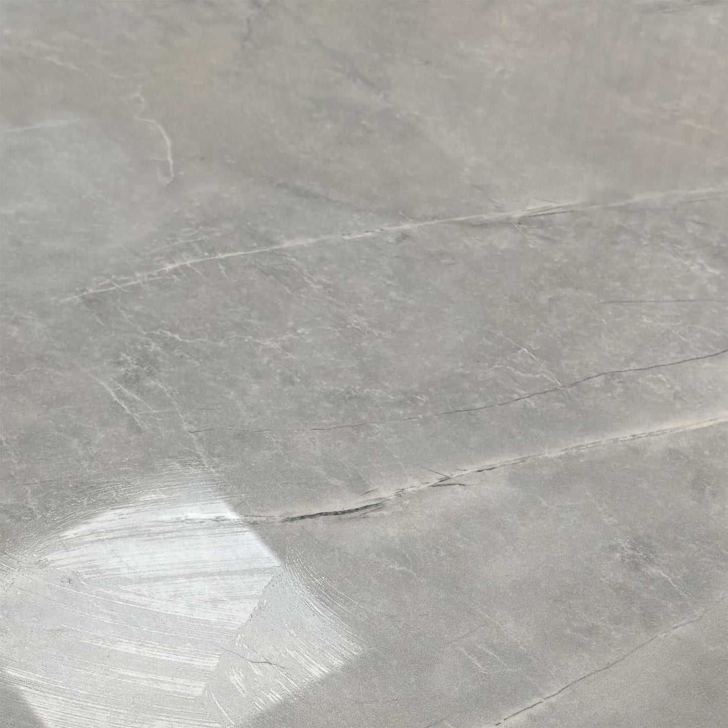 Close-up of the high-gloss marble-effect ceramic top, demonstrating the durable, scratch-resistant texture.