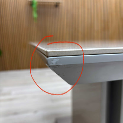 Close-up image highlighting the small defect on the side of the table for transparency.