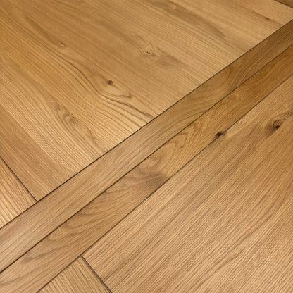 Close-up of the table surface, showing the protective clear lacquer finish that enhances the natural oak texture and clean lines.