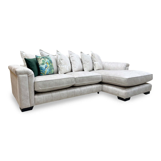 Front view of the DFS 'Dolcie' cream chaise sofa, featuring a sophisticated right-hand facing configuration and plush pillow back design.