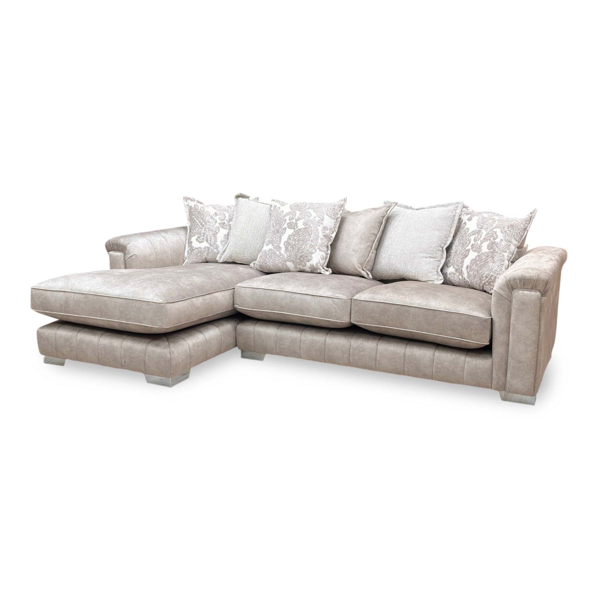 Full view of a luxurious DFS 'Dolcie' left-hand facing 3 seat chaise sofa upholstered in warm oatmeal combination velvet.