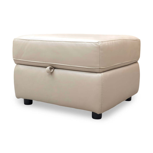 Full view of the leather footstool, showing the thick cushioned top and clean, versatile design suitable for any decor.