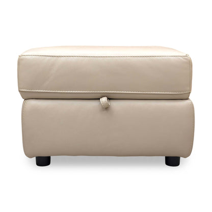 Front view of the leather footstool, showing the thick cushioned top and clean, versatile design suitable for any decor.