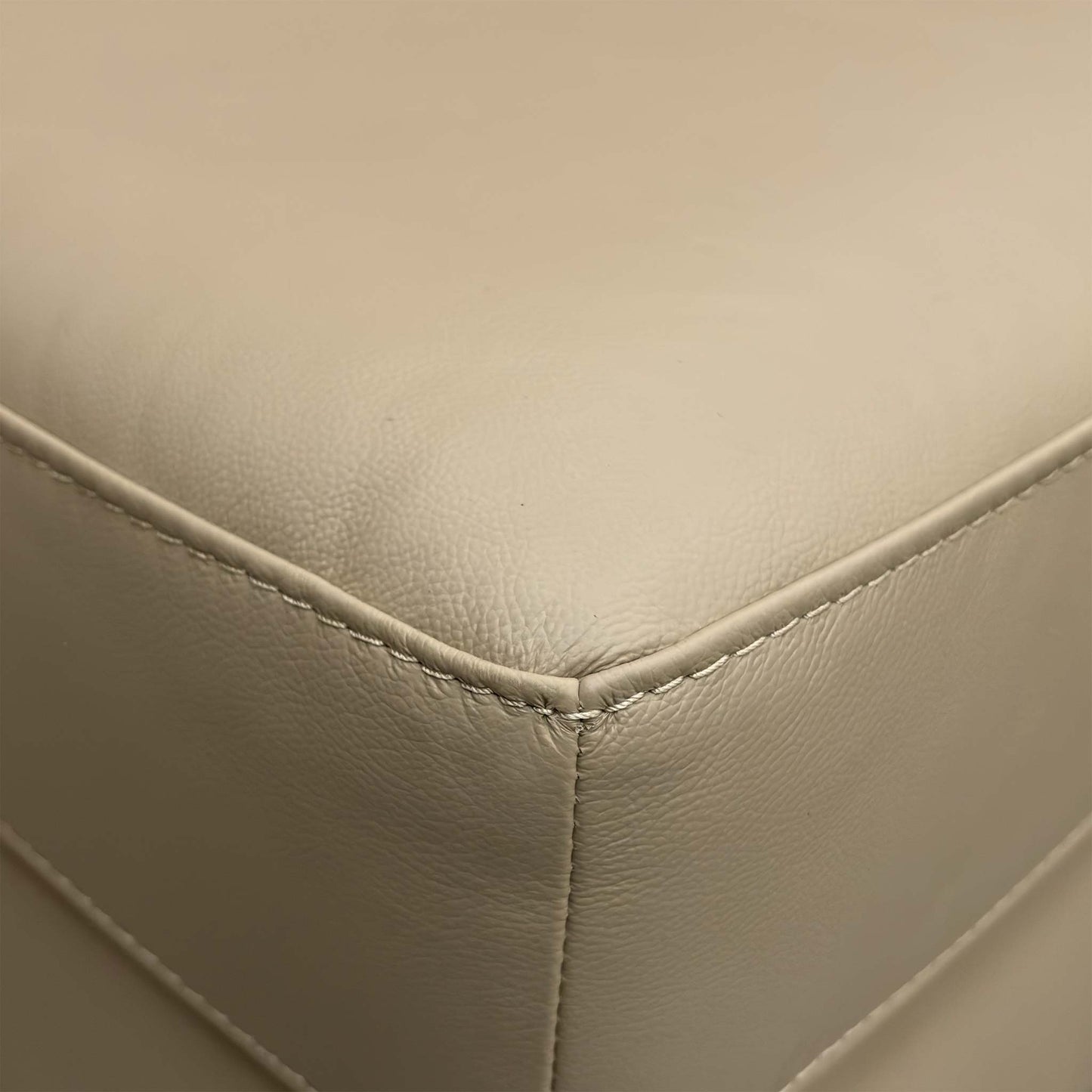 Close-up of the pebble leather texture, highlighting the quality grain and durable finish of the upholstery.