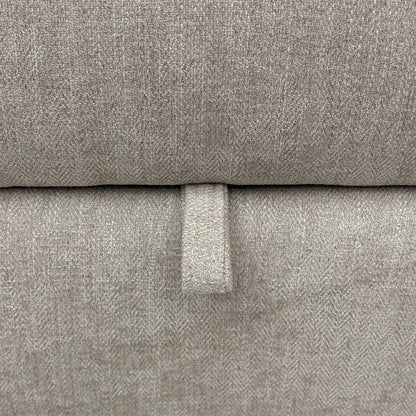 Close-up of the grey fabric upholstery, highlighting the durable weave texture, neutral tone, and quality stitched seams.