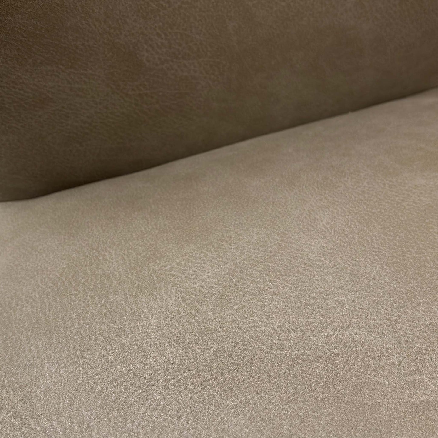 Detail of the brushed stainless steel legs, showcasing the high-quality metal finish and sturdy build of the chair.