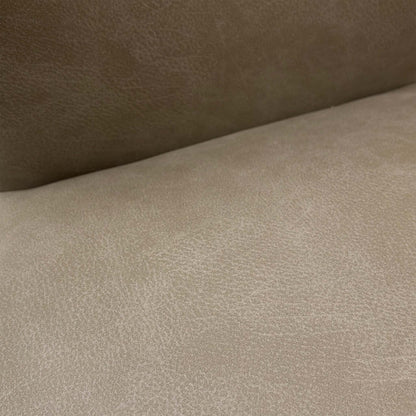 Detail of the brushed stainless steel legs, showcasing the high-quality metal finish and sturdy build of the chair.