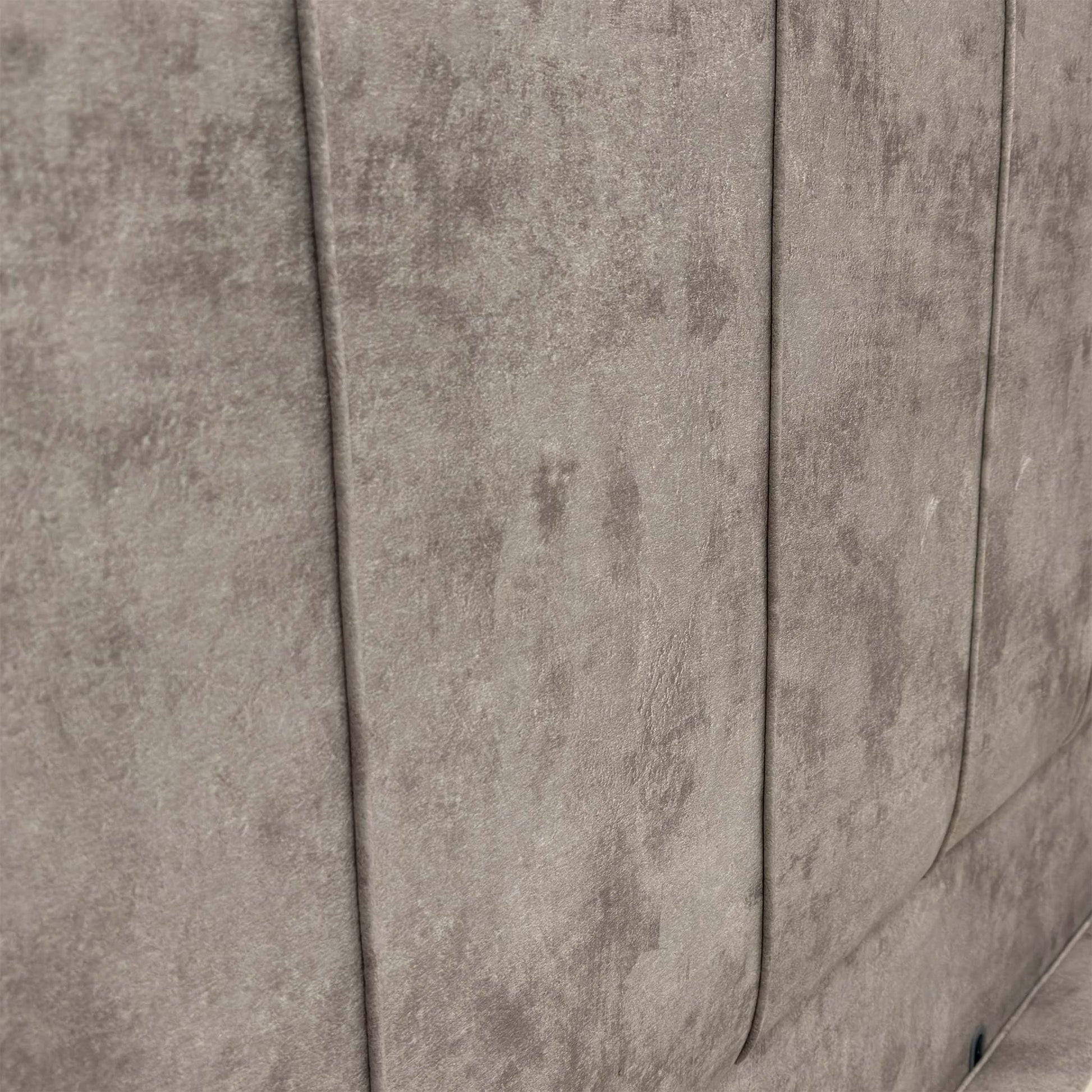 Close-up of the floor-standing headboard, showcasing the luxurious Dapple Stone velvet upholstery and refined vertical panel detailing.