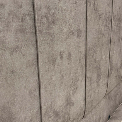 Close-up of the floor-standing headboard, showcasing the luxurious Dapple Stone velvet upholstery and refined vertical panel detailing.