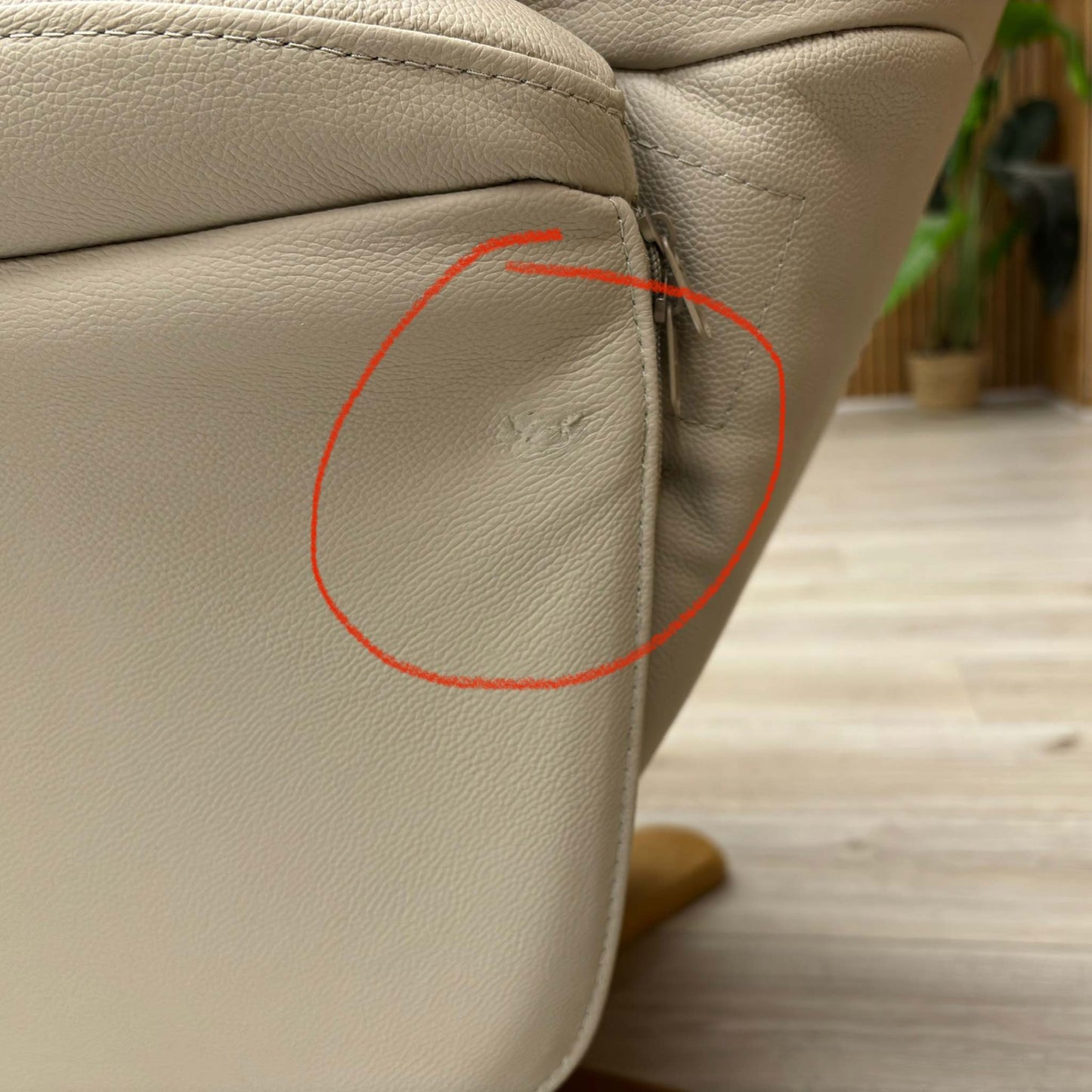Close-up of the damage on Mushroom leather upholstery.