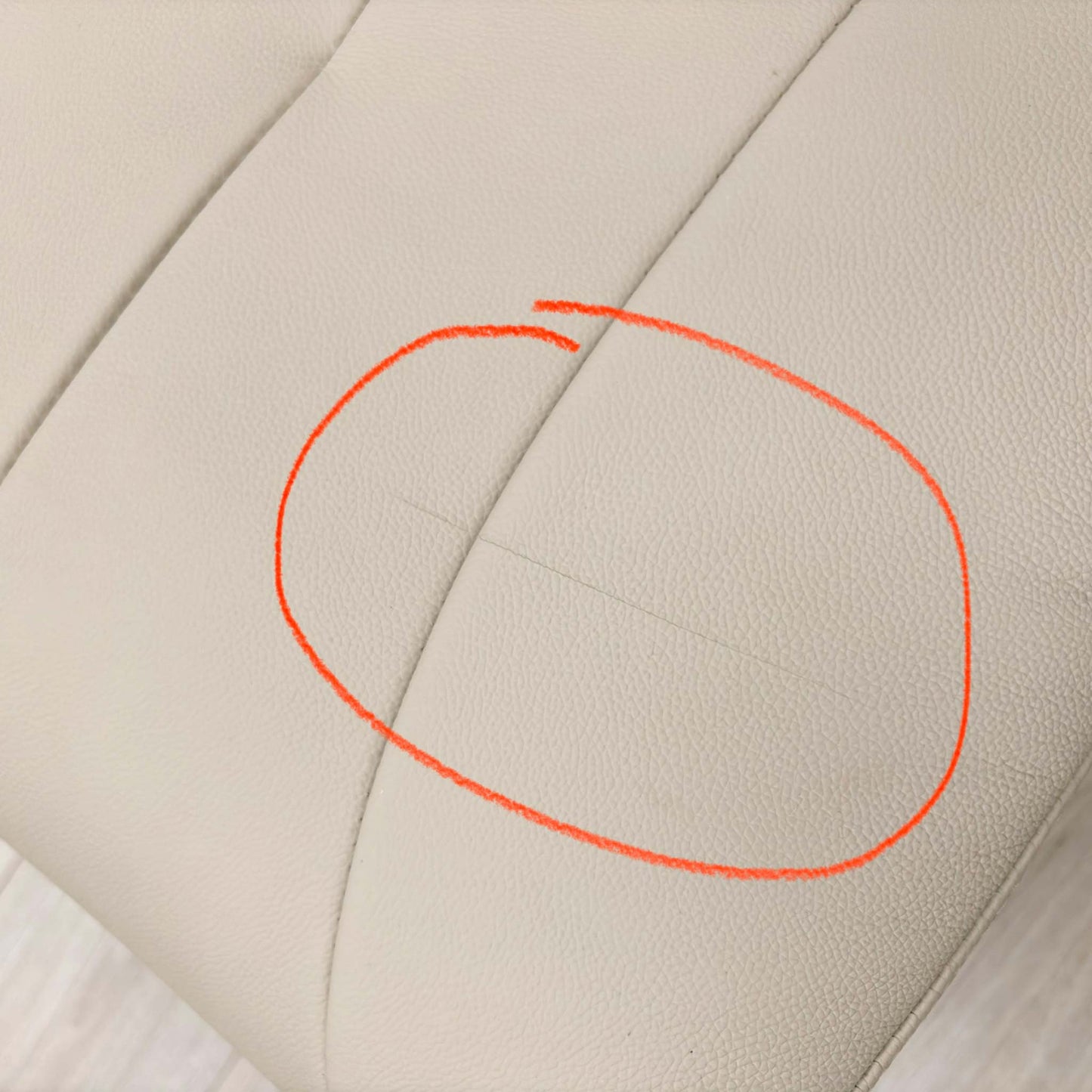 Close-up of the damage on Mushroom leather upholstery.