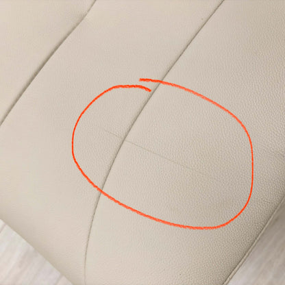 Close-up of the damage on Mushroom leather upholstery.