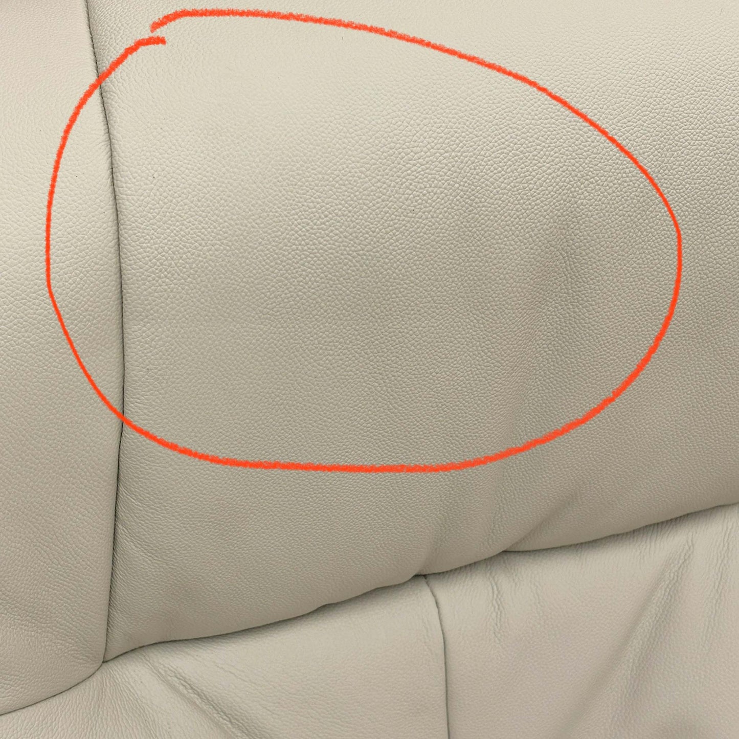 Close-up of the damage on Mushroom leather upholstery.