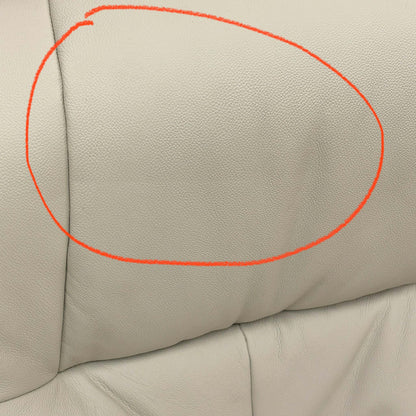 Close-up of the damage on Mushroom leather upholstery.