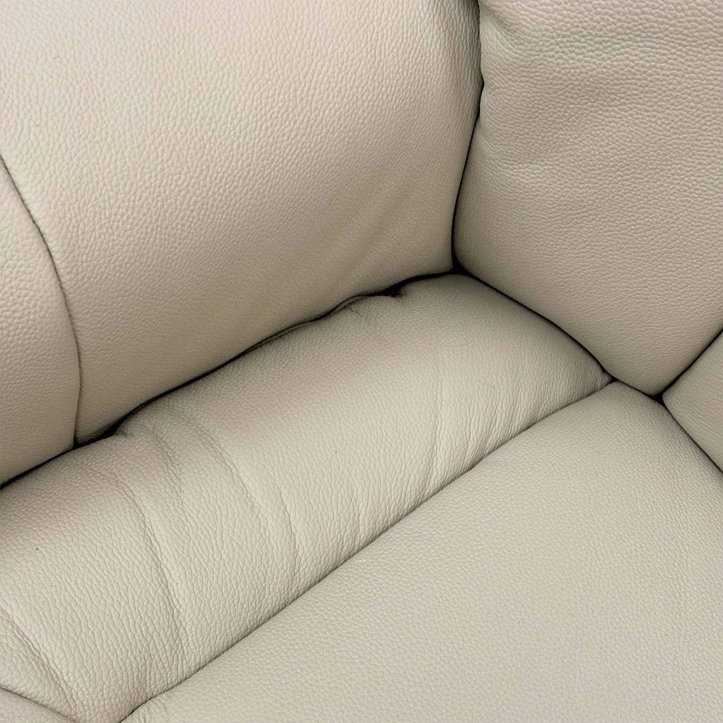 Close-up of the Mushroom leather upholstery, highlighting the fine grain texture and the quality of the top-stitch detailing.
