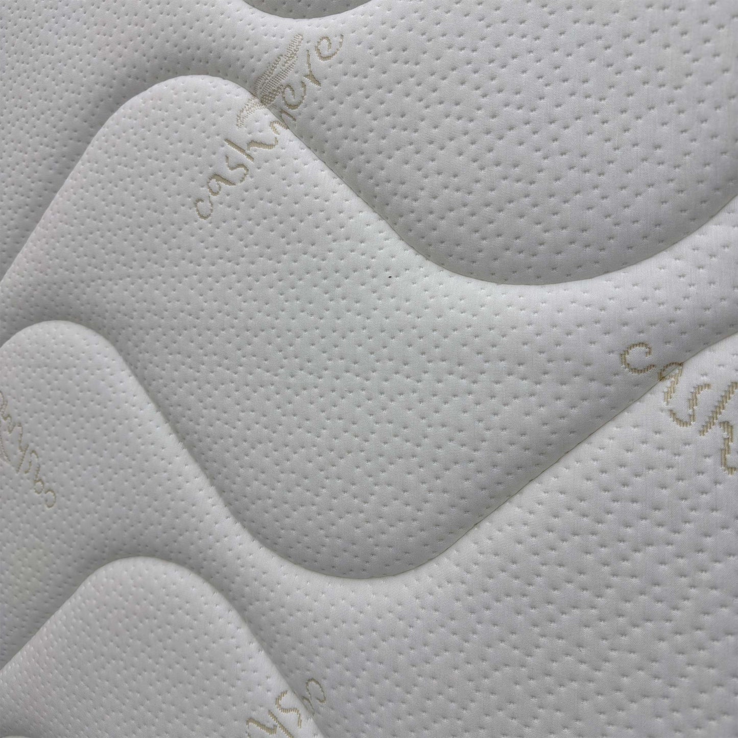 Close-up of the breathable top fabric and tufted detailing, highlighting the soft-to-the-touch texture and cooling weave.